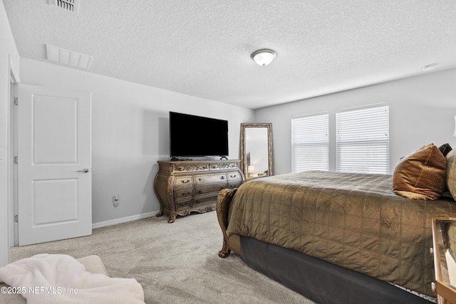 carpeted bedroom featuring a textured ceiling