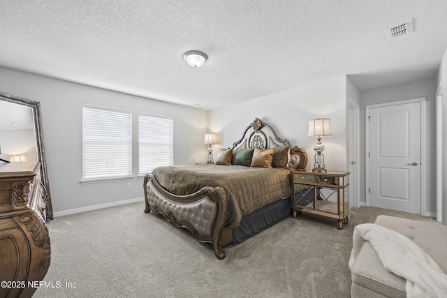 bedroom featuring light colored carpet and a textured ceiling