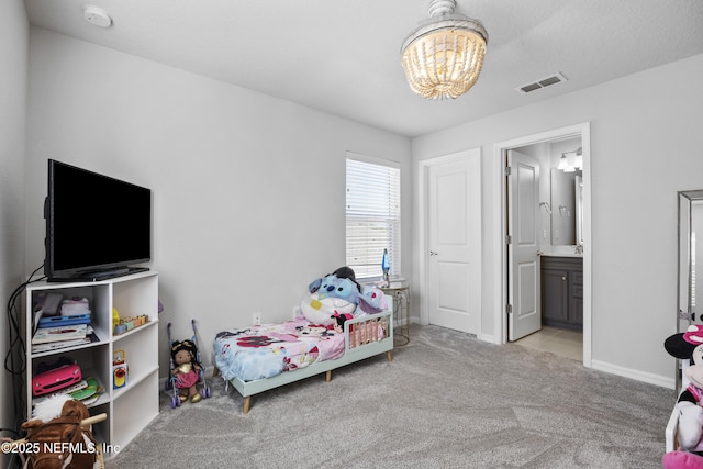 bedroom with light carpet, an inviting chandelier, and ensuite bathroom