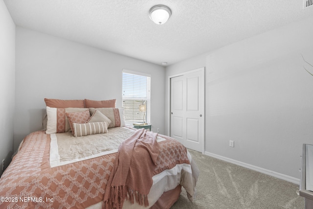 carpeted bedroom with a textured ceiling