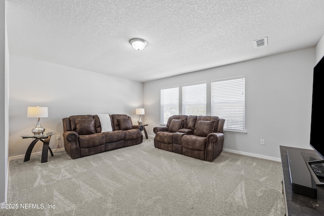 carpeted living room featuring a textured ceiling