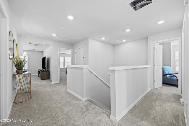 hallway featuring light colored carpet