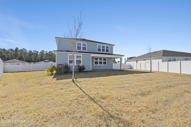 back of property featuring a yard