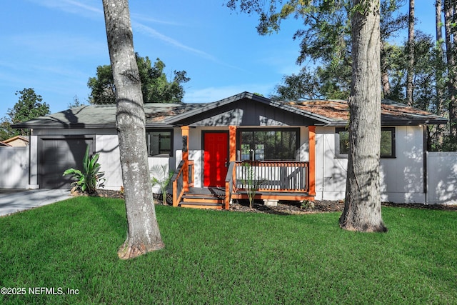 view of front of property featuring a garage and a front lawn