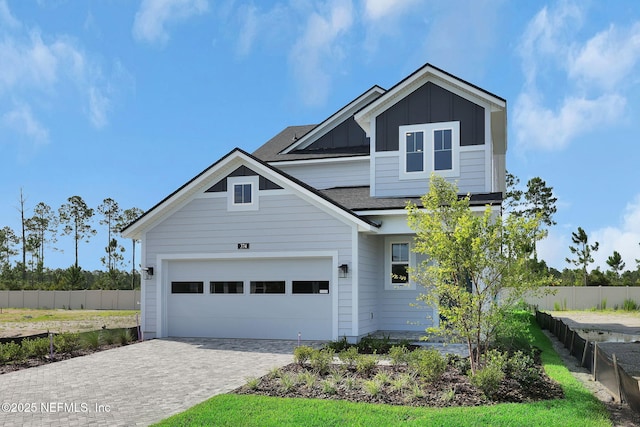 374 Sutton Dr, Ponte Vedra, FL 32081 - traditional-style home featuring board and batten siding, decorative driveway, roof with shingles, and an attached garage