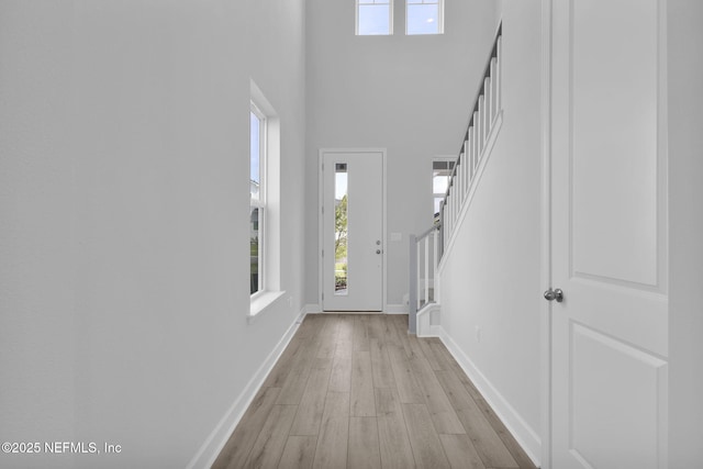 374 Sutton Dr, Ponte Vedra, FL 32081 - foyer with light wood finished floors, plenty of natural light, a towering ceiling, and stairs