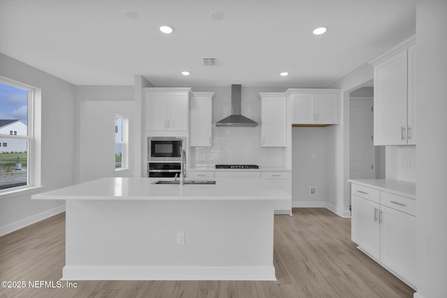 374 Sutton Dr, Ponte Vedra, FL 32081 - kitchen featuring wall chimney range hood, appliances with stainless steel finishes, decorative backsplash, white cabinetry, and recessed lighting