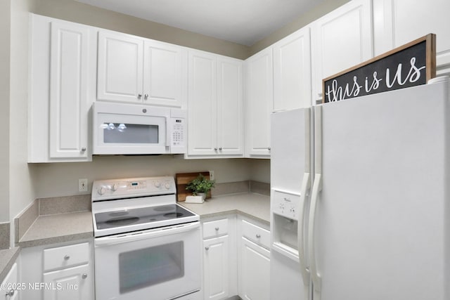 kitchen featuring white cabinets and white appliances