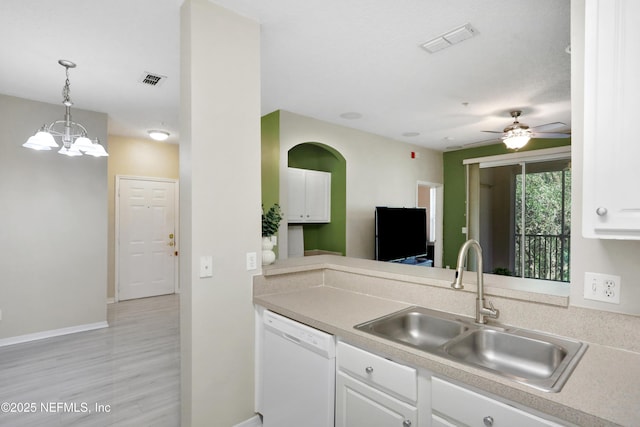 kitchen featuring dishwasher, white cabinets, ceiling fan with notable chandelier, sink, and decorative light fixtures