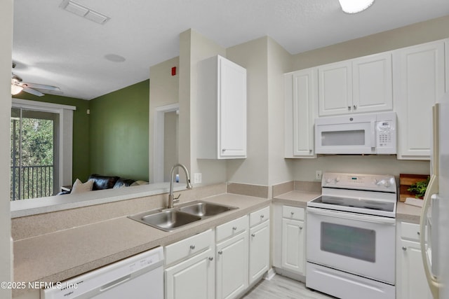 kitchen featuring white cabinets, white appliances, ceiling fan, and sink