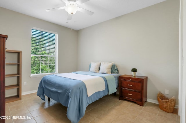 bedroom with ceiling fan and light tile patterned flooring