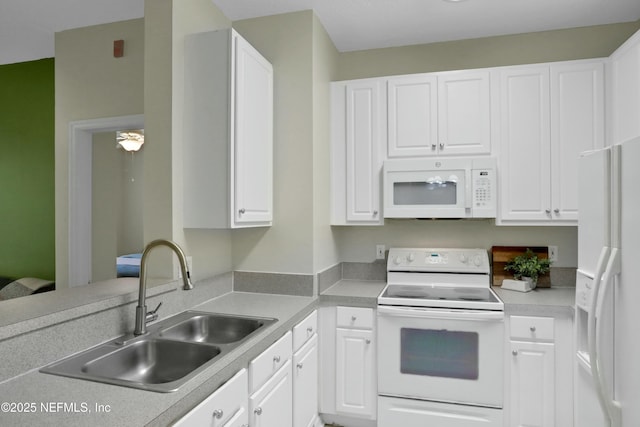 kitchen featuring white cabinetry, white appliances, and sink