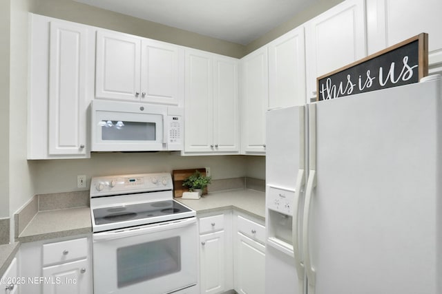 kitchen with white cabinetry and white appliances