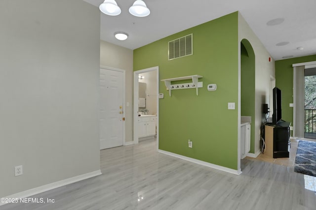 corridor with light hardwood / wood-style flooring