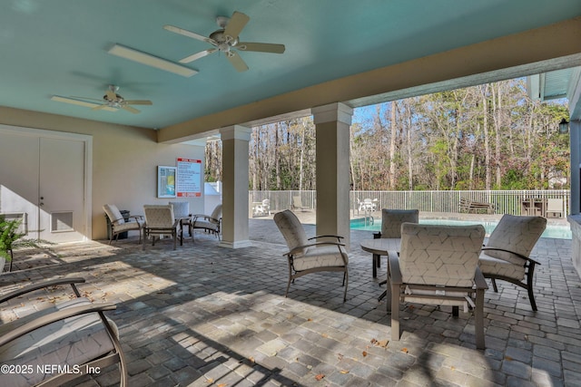 view of patio / terrace with a fenced in pool and ceiling fan