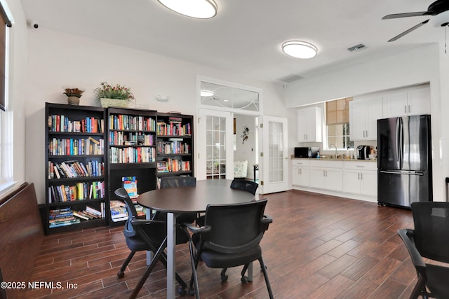 dining room featuring ceiling fan, french doors, and sink