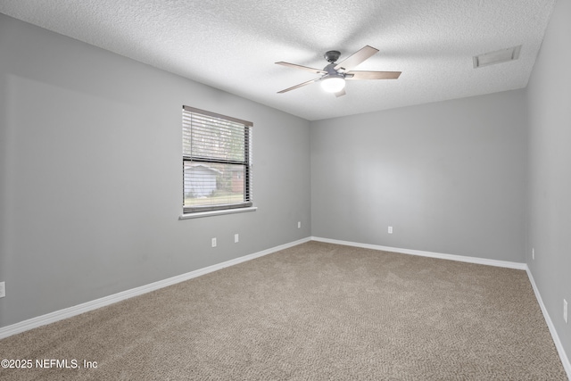 carpeted empty room featuring a textured ceiling and ceiling fan