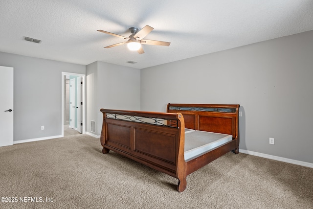 carpeted bedroom with ceiling fan and a textured ceiling