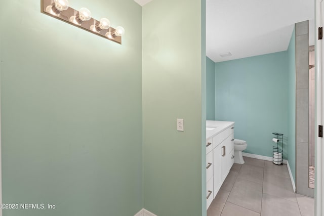 bathroom with toilet, tile patterned flooring, and vanity