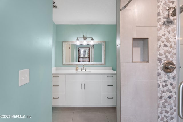 bathroom with vanity, tile patterned floors, and walk in shower