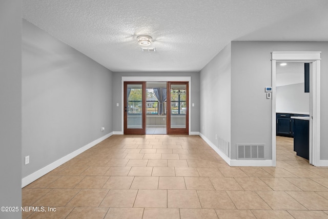 entryway featuring a textured ceiling and light tile patterned flooring