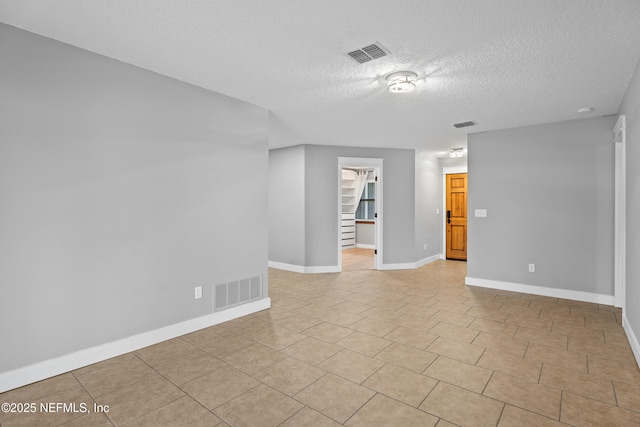 spare room featuring a textured ceiling