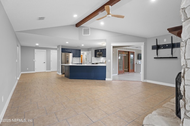 kitchen with ceiling fan, a breakfast bar area, decorative backsplash, lofted ceiling with beams, and appliances with stainless steel finishes