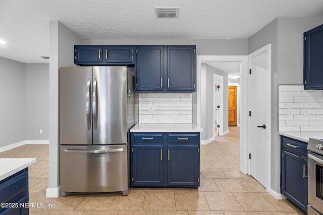 kitchen featuring blue cabinets, appliances with stainless steel finishes, and decorative backsplash