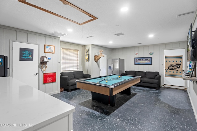 game room with a textured ceiling and billiards