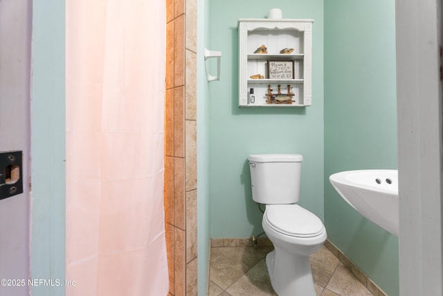 bathroom with tile patterned flooring and toilet