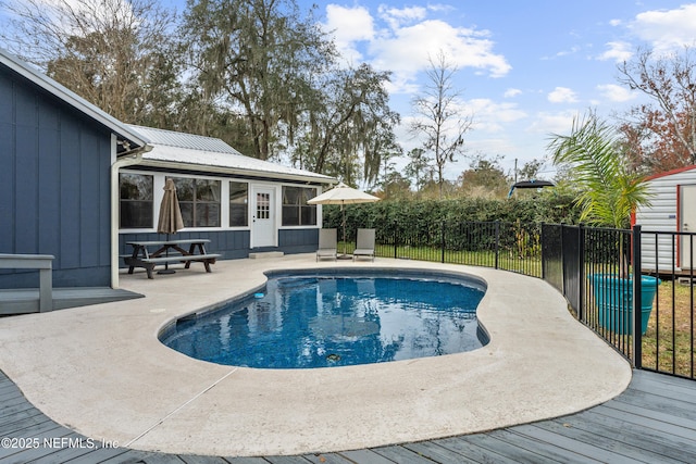 view of pool with a patio area and a sunroom