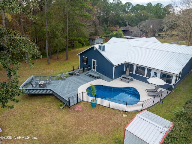 view of swimming pool with a yard and a wooden deck