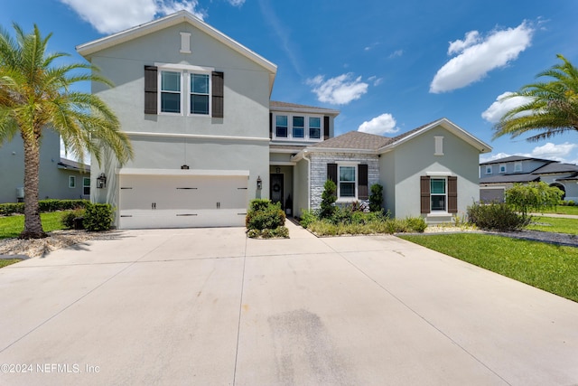 view of front of house with a garage and a front lawn