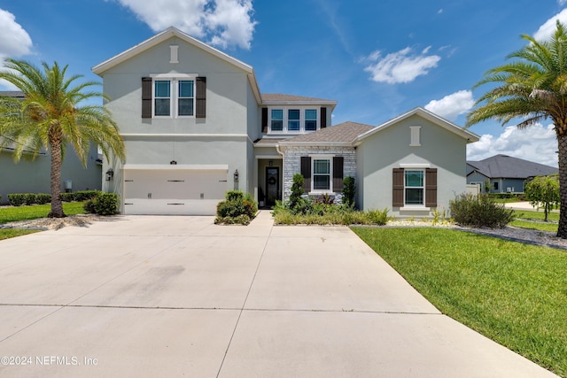 view of front of house with a garage and a front yard