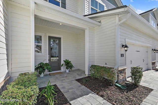 doorway to property featuring a garage