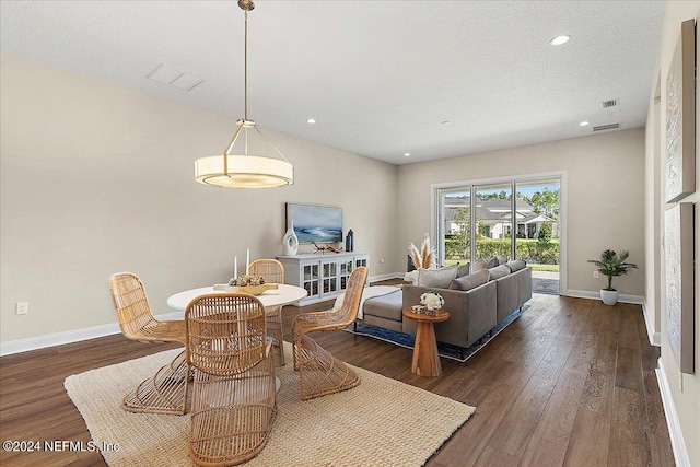 living room featuring dark hardwood / wood-style floors and a textured ceiling