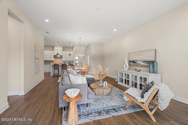 living room with dark hardwood / wood-style floors and a textured ceiling