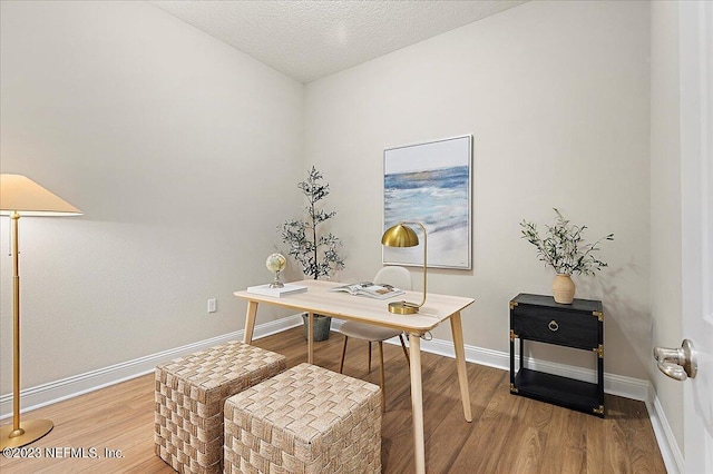 office space with hardwood / wood-style floors and a textured ceiling