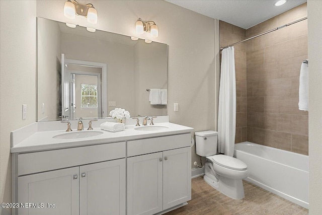 full bathroom featuring shower / bathtub combination with curtain, vanity, wood-type flooring, and toilet