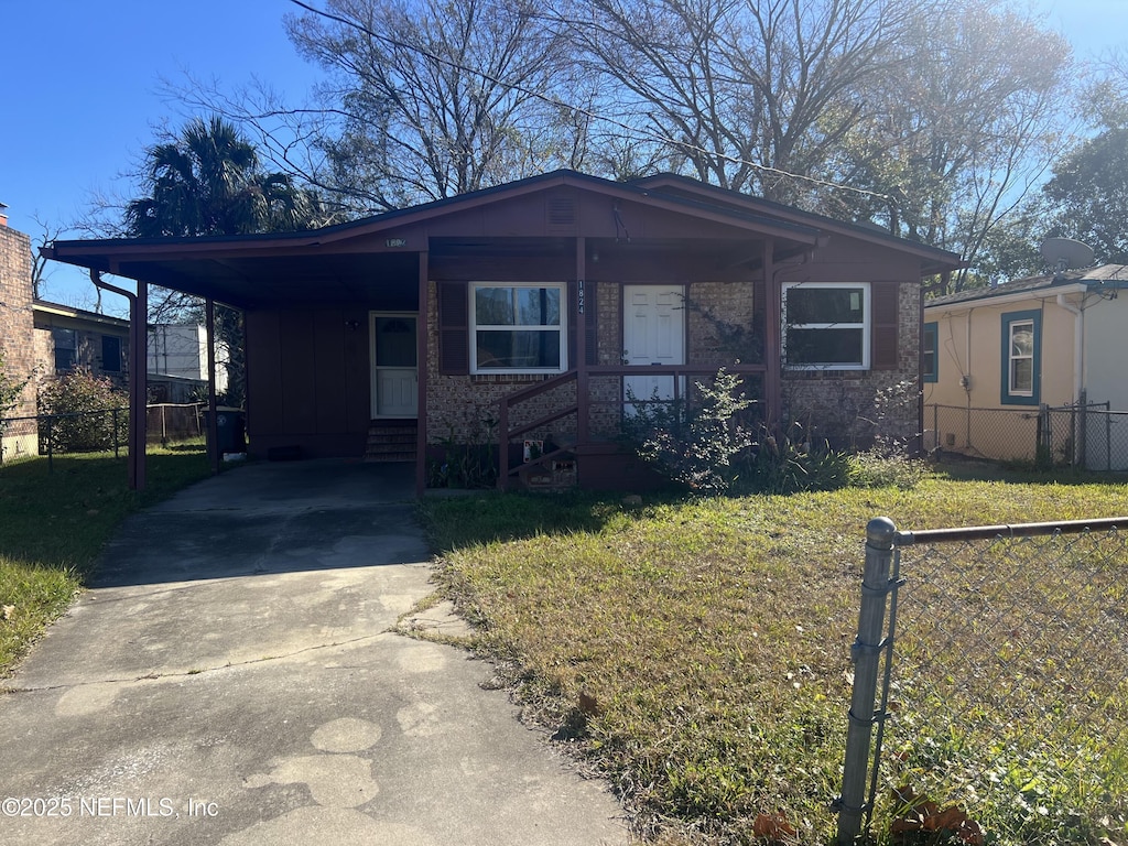 view of front of property with a front lawn and a carport