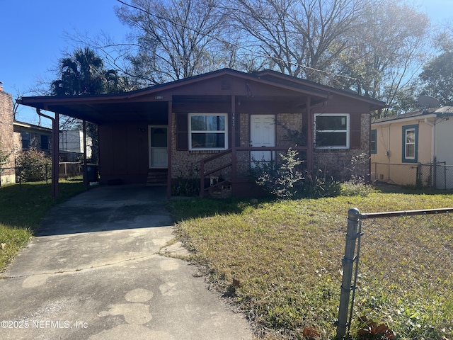 view of front of property with a front lawn and a carport