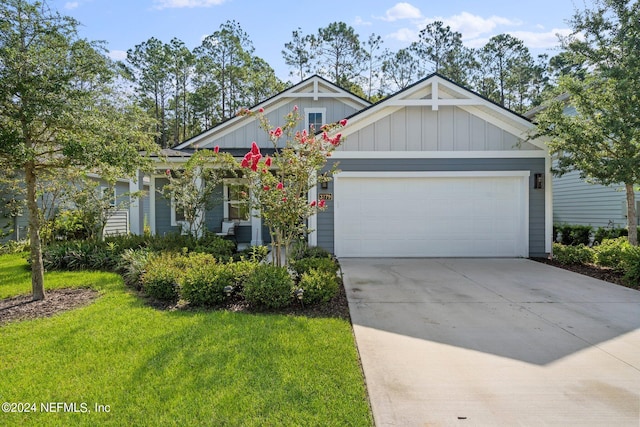 view of front of home with a garage and a front lawn