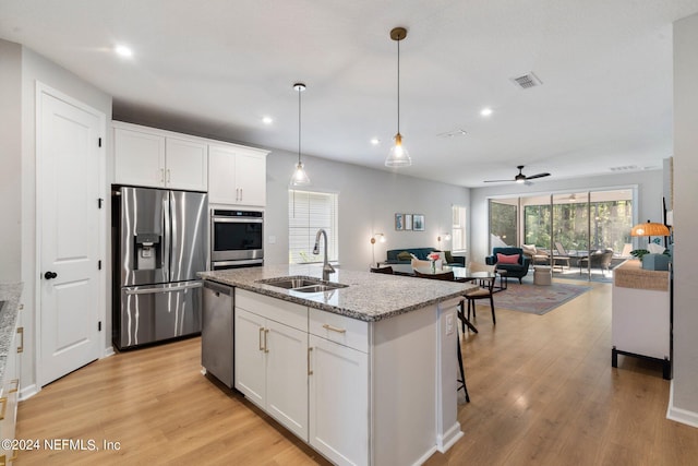 kitchen with appliances with stainless steel finishes, white cabinetry, ceiling fan, and sink