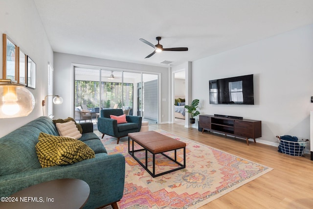 living room with ceiling fan and wood-type flooring