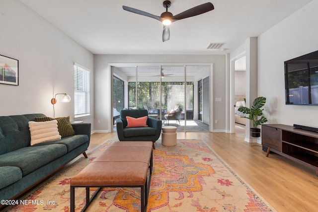 living room with ceiling fan and light wood-type flooring