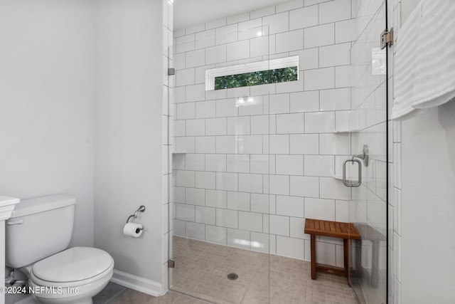 bathroom with tile patterned flooring, an enclosed shower, and toilet