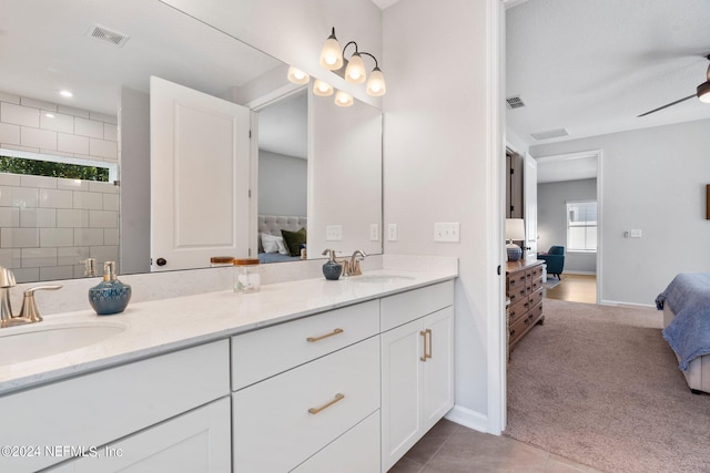 bathroom with ceiling fan, tile patterned flooring, vanity, and a shower with shower door