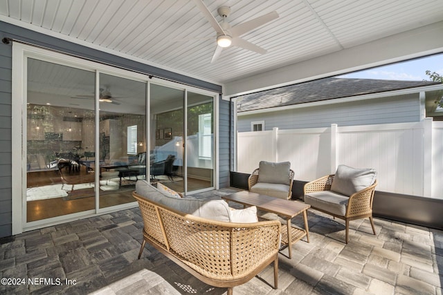 sunroom featuring ceiling fan and a healthy amount of sunlight