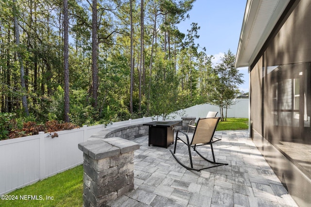 view of patio / terrace featuring an outdoor fire pit