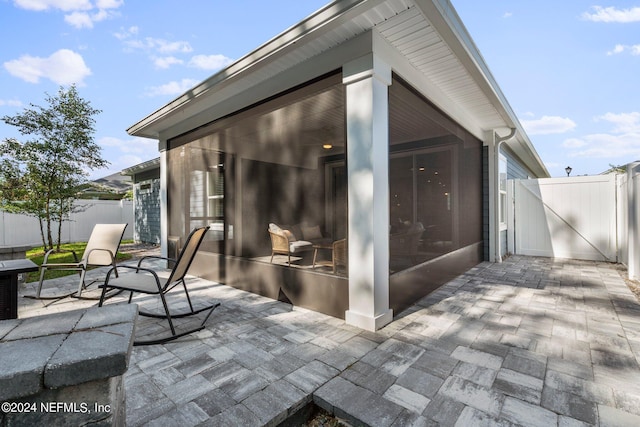 view of patio / terrace featuring a sunroom